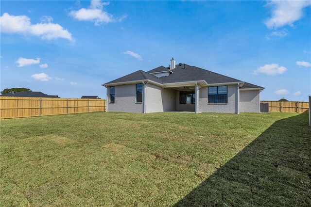 rear view of property featuring a yard