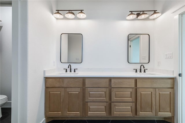 bathroom with tile patterned flooring, vanity, and toilet