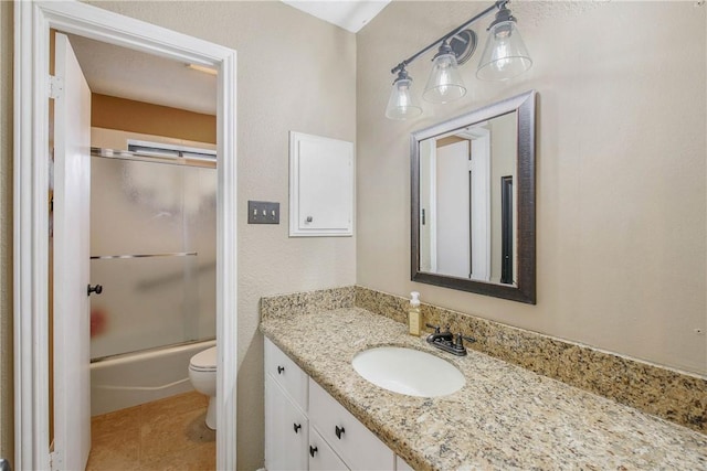 full bathroom with toilet, tile patterned flooring, combined bath / shower with glass door, and vanity