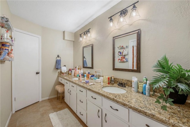 bathroom featuring baseboards, vanity, and tile patterned floors