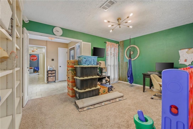 playroom featuring a chandelier, carpet, visible vents, and a textured ceiling