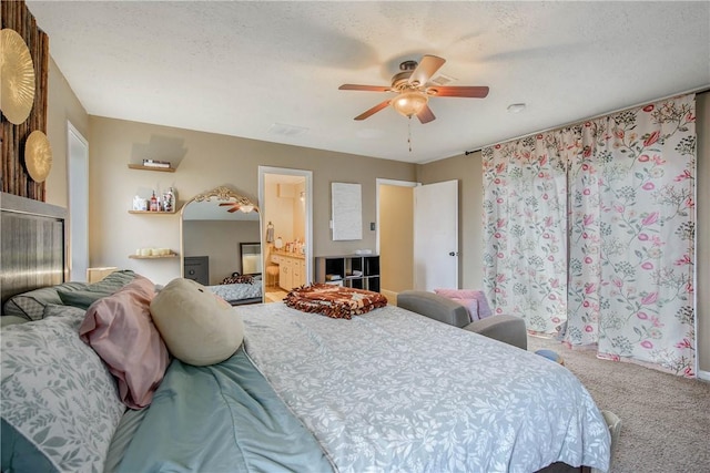 bedroom featuring a textured ceiling, ceiling fan, ensuite bath, and carpet flooring