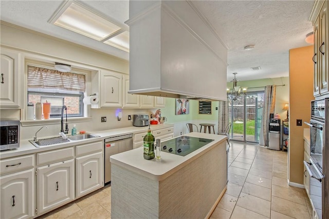 kitchen with light tile patterned floors, a sink, light countertops, black appliances, and decorative light fixtures