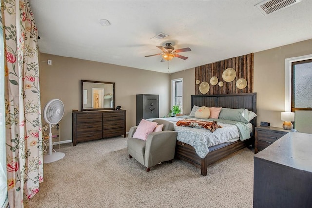 bedroom featuring ceiling fan, visible vents, baseboards, and light colored carpet