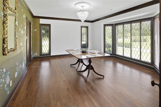 unfurnished dining area featuring dark hardwood / wood-style floors, ornamental molding, and a chandelier