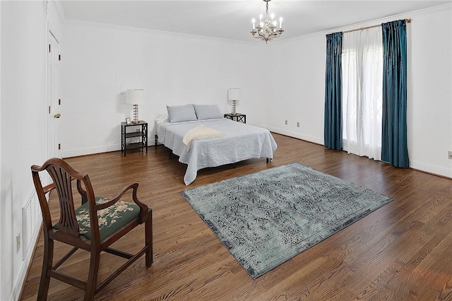 bedroom featuring crown molding, dark hardwood / wood-style flooring, and a notable chandelier