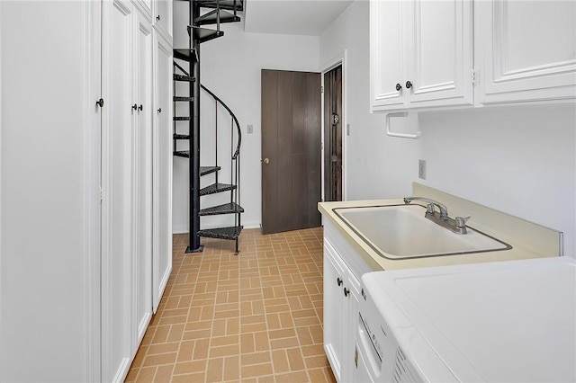 laundry area with cabinets, washer / clothes dryer, and sink