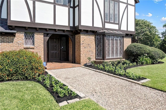 doorway to property featuring a lawn