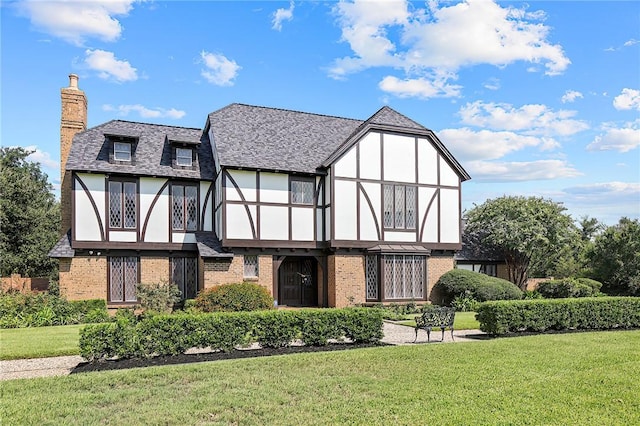 rear view of property with a lawn