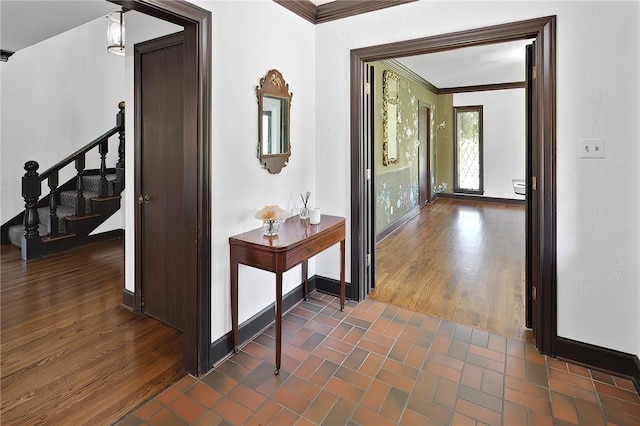 hall with dark hardwood / wood-style flooring and ornamental molding