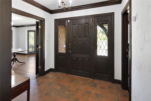 foyer entrance with an inviting chandelier and ornamental molding