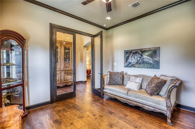 living room with french doors, ornamental molding, dark wood-type flooring, and ceiling fan