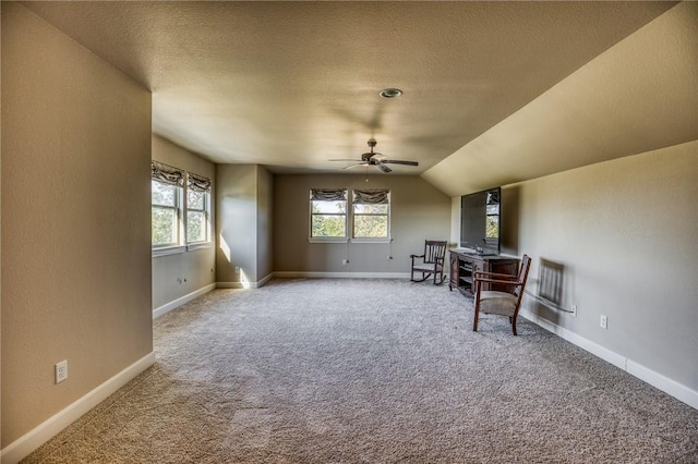 sitting room featuring a textured ceiling, ceiling fan, lofted ceiling, and carpet floors