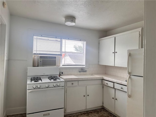 kitchen with white cabinetry, sink, cooling unit, decorative backsplash, and white appliances