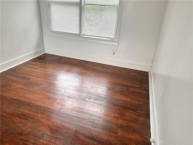 spare room featuring dark hardwood / wood-style flooring