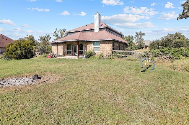 back of property featuring a lawn