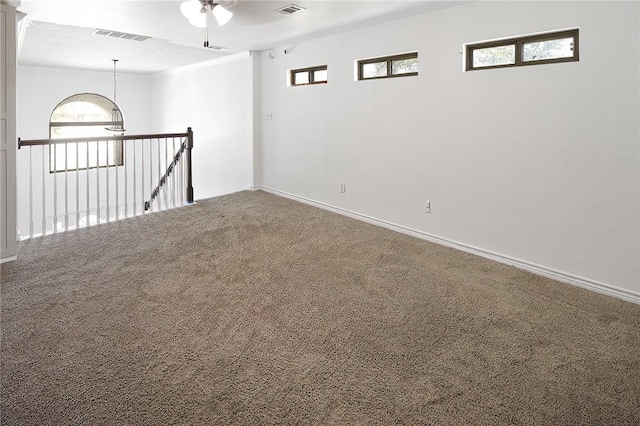 carpeted empty room featuring ceiling fan