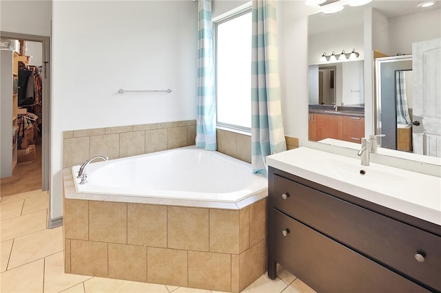 bathroom featuring tile patterned flooring, vanity, independent shower and bath, and a wealth of natural light