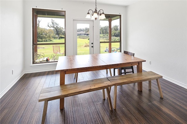 dining space with a notable chandelier and dark wood-type flooring