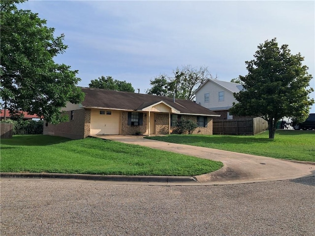 1202 Cheyenne Dr, Brenham, TX 77833 - view of front of home with an attached garage, concrete driveway, and brick siding