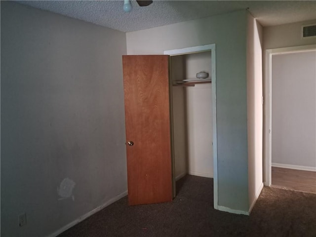 1202 Cheyenne Dr, Brenham, TX 77833 - unfurnished bedroom with carpet floors, a closet, and a textured ceiling