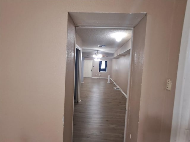 1202 Cheyenne Dr, Brenham, TX 77833 - hallway featuring dark wood finished floors and a textured ceiling