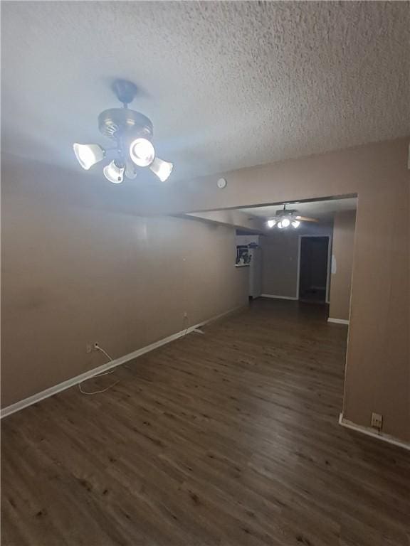 1202 Cheyenne Dr, Brenham, TX 77833 - unfurnished room with dark wood finished floors, a textured ceiling, and a smoke detector