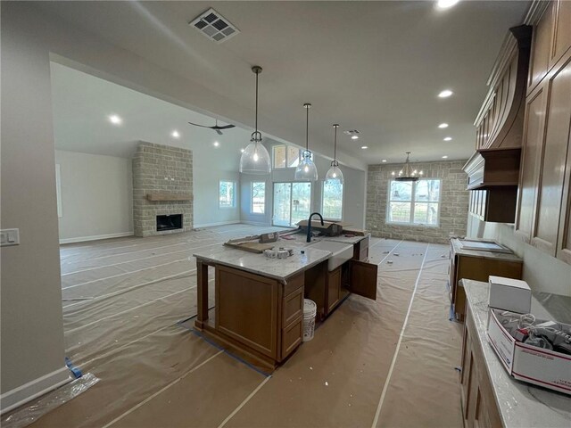 kitchen with a fireplace and vaulted ceiling