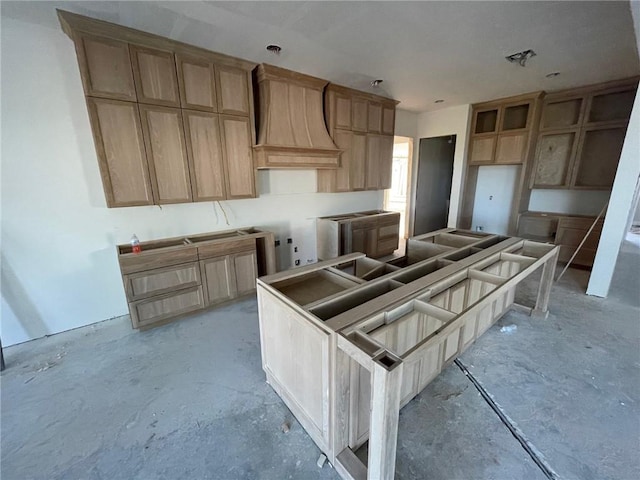 kitchen with a kitchen island and custom exhaust hood