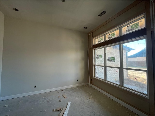 unfurnished room with concrete floors