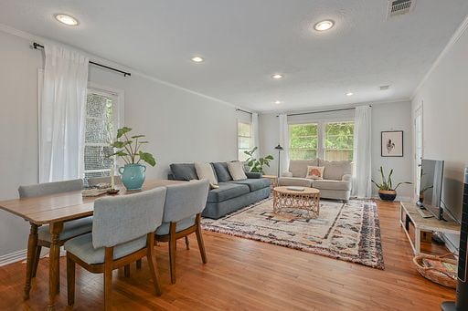 living room with hardwood / wood-style flooring and ornamental molding