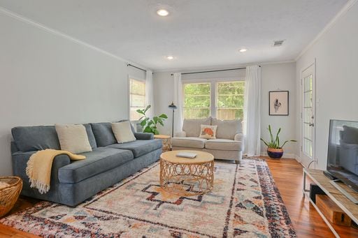 living room featuring ornamental molding and hardwood / wood-style floors