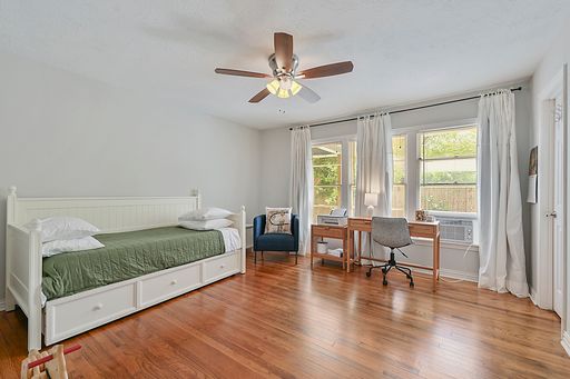 bedroom featuring wood-type flooring and ceiling fan