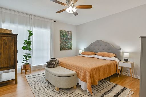 bedroom with light hardwood / wood-style floors and ceiling fan