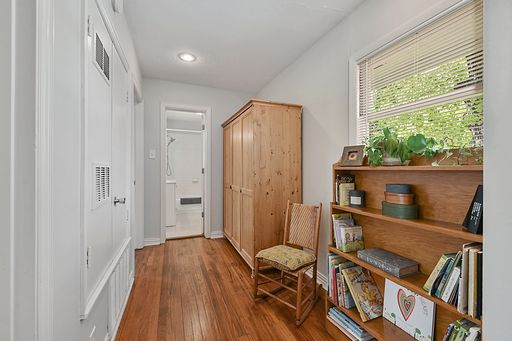 corridor with hardwood / wood-style flooring