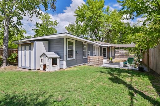 back of property with a lawn