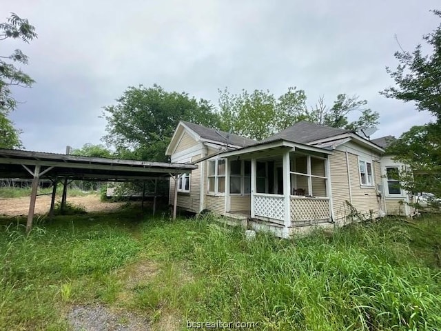 view of property exterior featuring a carport