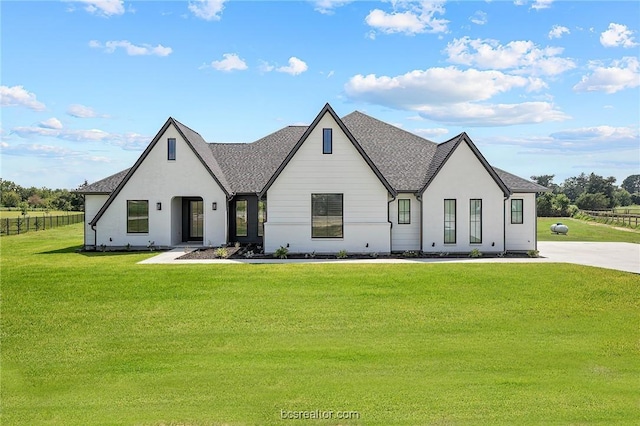 modern farmhouse style home with a front yard