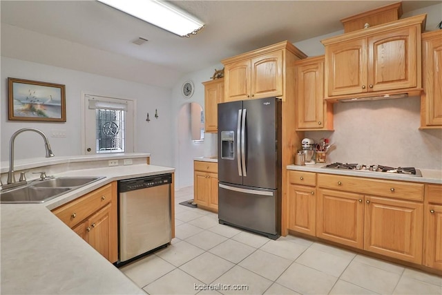 kitchen featuring light brown cabinets, sink, stainless steel appliances, and light tile patterned flooring