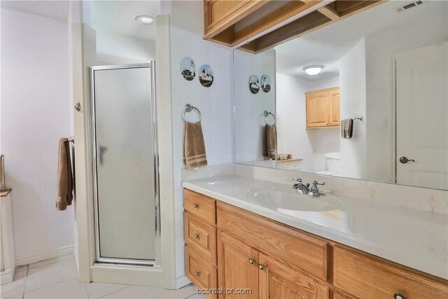 bathroom with vanity, tile patterned floors, and a shower with door