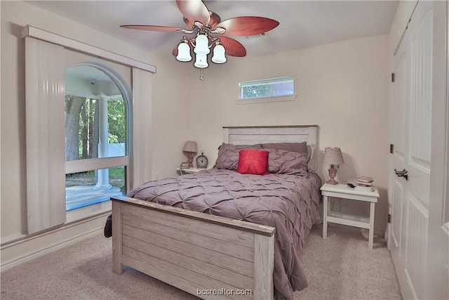 bedroom featuring light colored carpet and ceiling fan