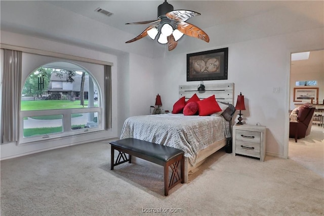 bedroom featuring light carpet and ceiling fan