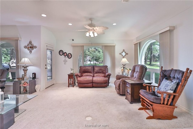 carpeted living room featuring plenty of natural light and ceiling fan