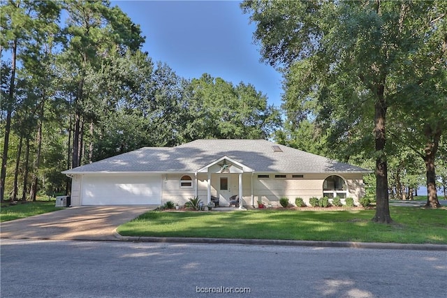 ranch-style home featuring a garage and a front lawn