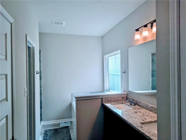 1938 Chief St, Bryan, TX 77807 - bathroom featuring double vanity and baseboards