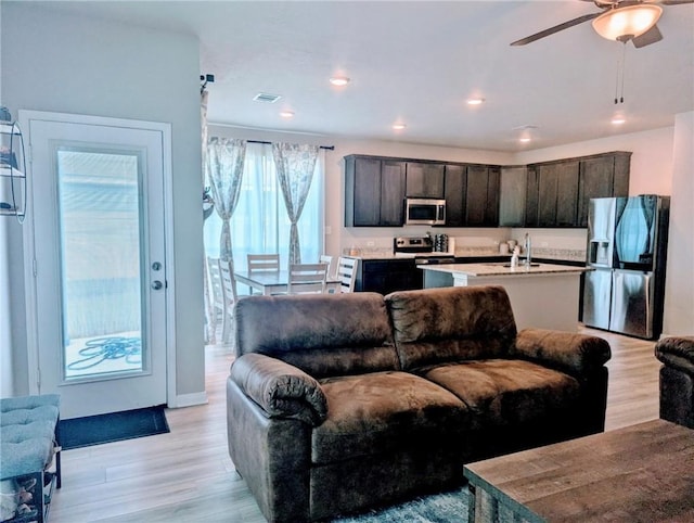 1938 Chief St, Bryan, TX 77807 - living area featuring light wood-style flooring and a ceiling fan