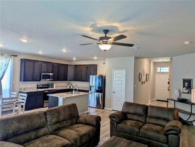 1938 Chief St, Bryan, TX 77807 - living room with healthy amount of natural light, light wood-style floors, ceiling fan, and recessed lighting