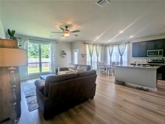 1938 Chief St, Bryan, TX 77807 - living area with wood finished floors, ceiling fan, and recessed lighting
