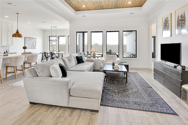 living room with light wood-style floors, wood ceiling, visible vents, and a tray ceiling