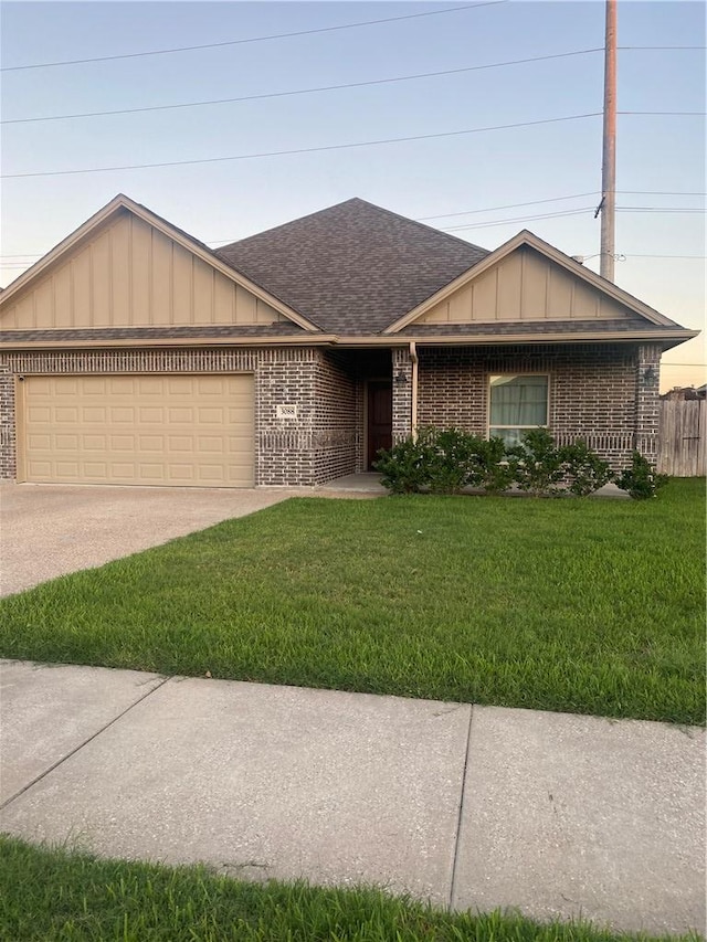 ranch-style home with a garage and a front lawn